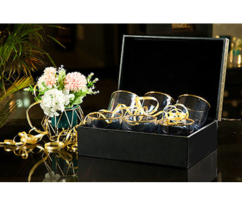 Stylish blue and gold whiskey glasses in gift box