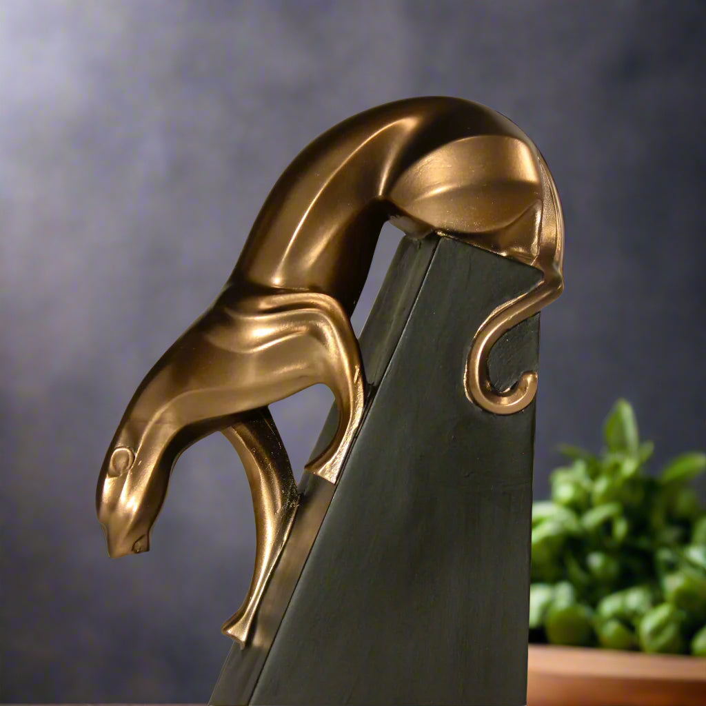Stylized resin panther with bronze detailing for luxury interior themes