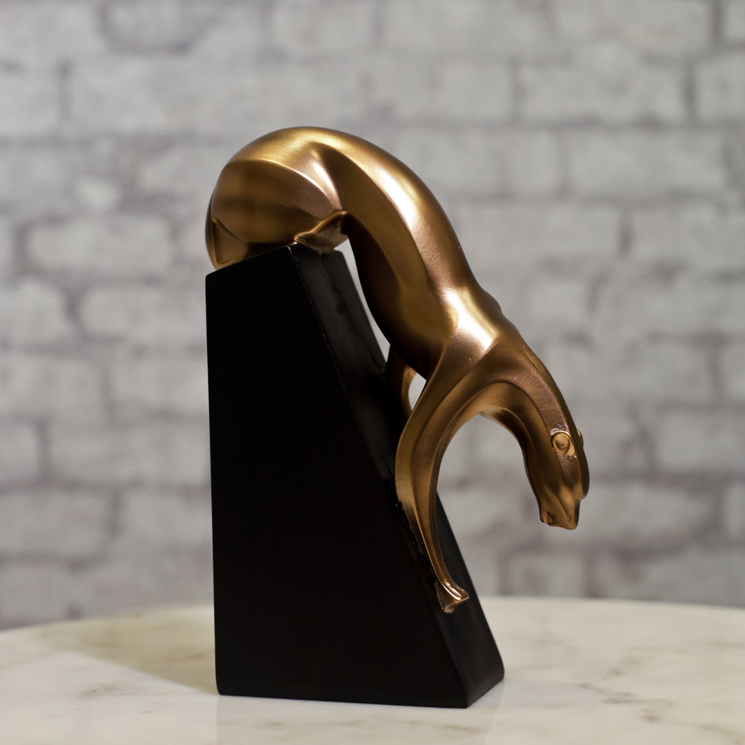 Bronze-toned resin sculpture of a panther in a sleek, forward-moving pose