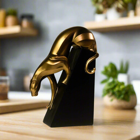 Resin sculpture of a prowling panther in bronze finish, captured mid-stride

