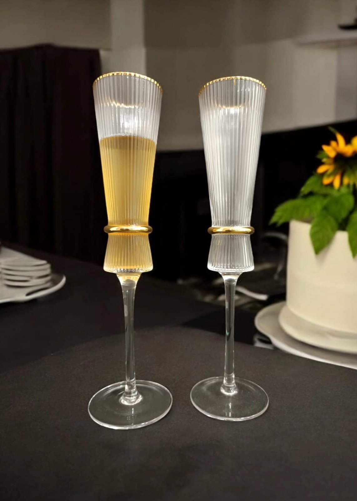  fluted champagne glasses with gold rims.