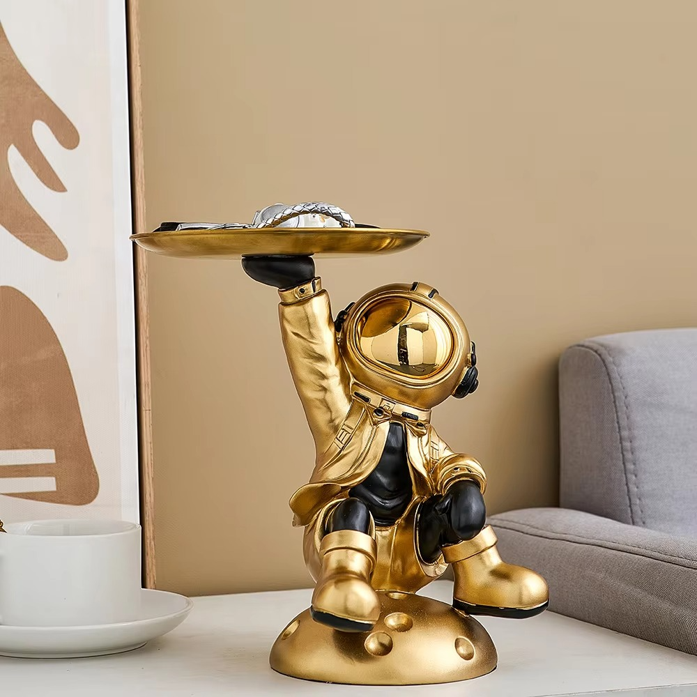 Modern astronaut statue with a metal tray, perfect as a stylish tabletop accessory

