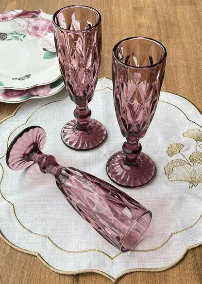 Pink cut-glass flutes on a floral placemat
