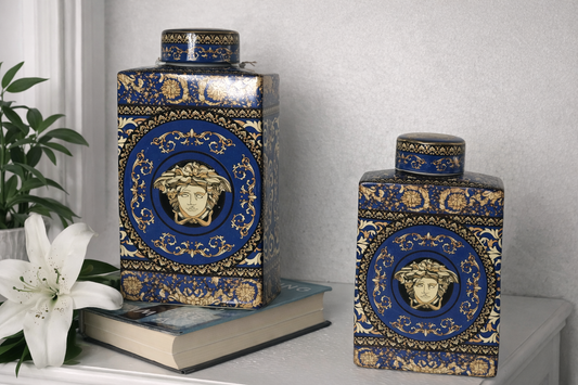 Elegant blue and gold ceramic decor jars with Medusa design placed on a side table, perfect for luxury home decoration