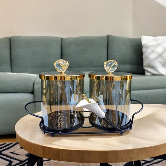 Glass jars with gold lids on a tray.